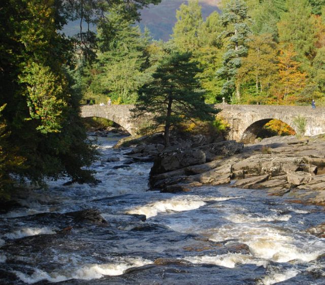 The falls of dochart in highland Perthshire and an old stone bridge